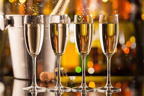 Four Full Champagne Flutes
